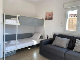 Chambre pour enfants avec lits superposés modernes et canapé, idéale pour familles au Mas du Camisard